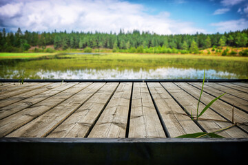 Wooden pier with planks at an idyllic lake