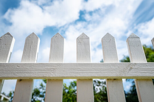 White picket fence under a blue sky