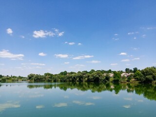 Fototapeta premium Summer rural landscape, lake and sky