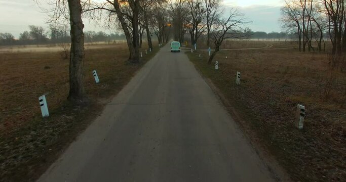 Road trip friends in hippie car. Aerial view of a retro van in fog. Road trip in&nbsp;mint minivan car in mist.&nbsp;Vintage bus rides in the fog, among the trees at dawn. Classic Bus Drives Next Down To River
