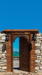 Wooden door and stone wall on the sea shore, open to the sea outdoors - İzmir / Urla sahil