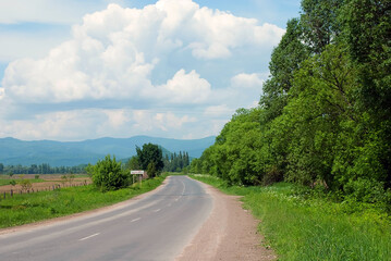 Fototapeta na wymiar Empty country side road for hitchhiking