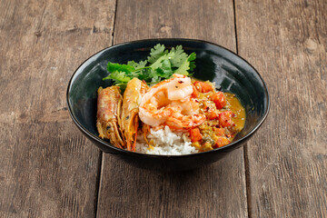 Asian dish curry with langoustines and hikari rice