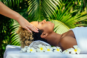 attractive african american female get treatment massage in tropics resort outdoor salon