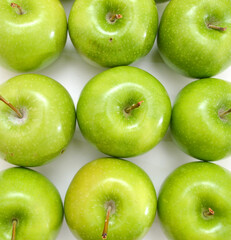 large group of green apples in a row