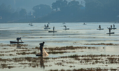 Fototapeta na wymiar Fishermen catching fish at lake in Dhar city of madhya pradesh state. India.