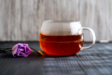 black tea in a transparent Cup  on a dark background