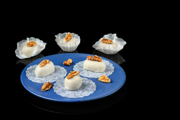 sweet walnut cameo on a blue ceramic plate seen at 45 degrees