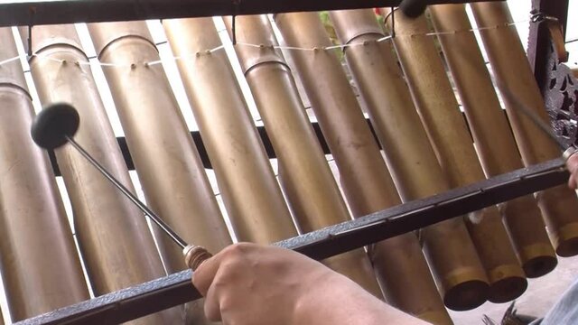 Musician playing Rindik, traditional musical instrument from Bali