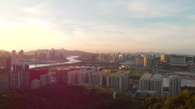 Rotating aerial shot flying by Goddess A-Ma statue to reveal Macau cityscape