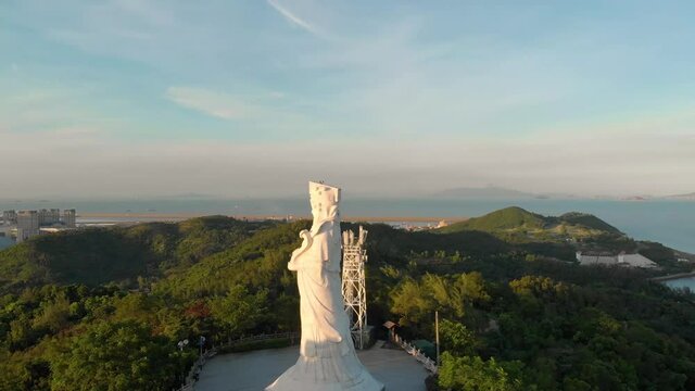 Rotating aerial revealing stunning scenery of Coloane, Macau behind Goddess A-Ma statue