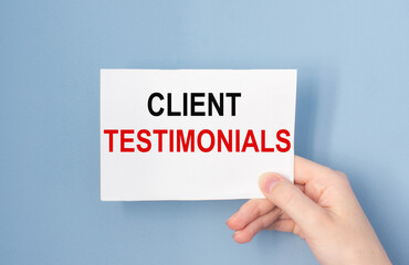Hand holding card with inscription Client Testimonials