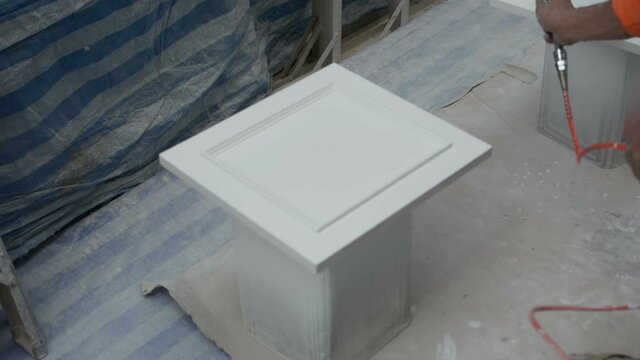 Painting funiture with spray gun .  Furniture manufacture.
