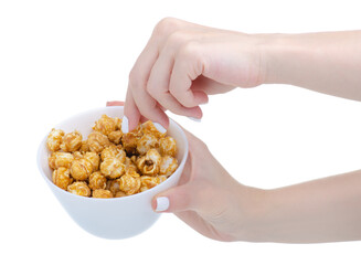 White bowl with caramel sweet popcorn in hand on white background isolation