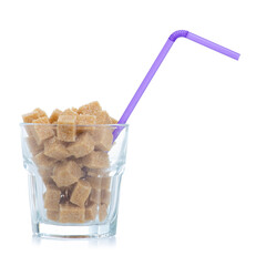 Glass with cane brown sugar cubes on white background isolation
