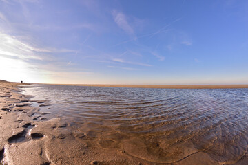 The beach and the sea coast on a sunny day in the fisheye lens.