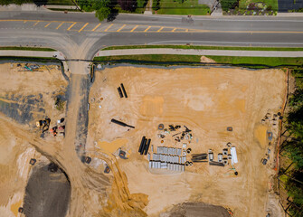 Construction of aerial top view on industrial equipment underground utility construction for pipes stacked in during plumbing construction