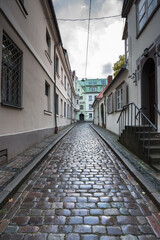 Picturesque street in Old Town of Riga, colorful, well preserved, historic buildings, cobble stones paved and winding narrow street, Riga, Latvia.