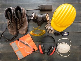 Work safety protection equipment background. Industrial protective gear on wooden table