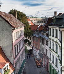 Fototapeta na wymiar Aerial view of a street in Old Town of Riga, colorful, well preserved, historic buildings, cobble stones paved and winding narrow street, Riga, Latvia.
