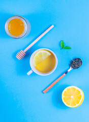 Fermented green tea, honey, lemon and mint on a blue background