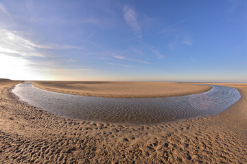 Fototapeta na wymiar The beach and the sea coast on a sunny day in the fisheye lens.