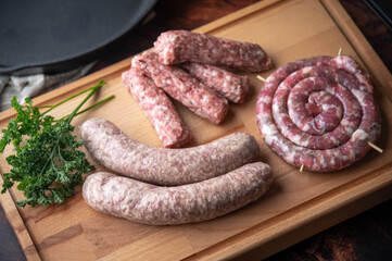 fresh sausages on wooden cutting board