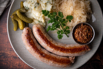 german sausage plate with mustard, potato salad and sauerkraut