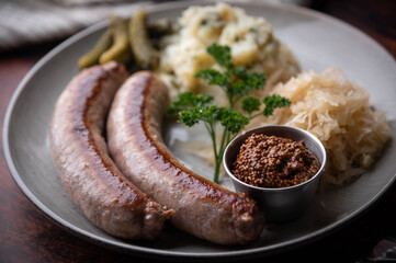 german sausage plate with mustard, potato salad and sauerkraut