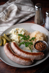 german sausage plate with mustard, potato salad and sauerkraut