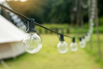 Outdoor string Light bulbs hanging on a line.