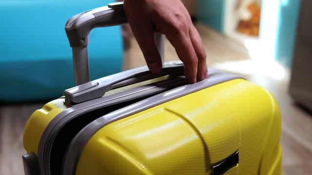 packing suitcase luggage including, hand sanitizer to protect coronavirus. hipster Travel holding clothes, summer vacation. New normal concept. COVID-19.