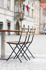 Empty table with chairs in the city center.