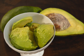 avocado butter, sliced on dark wooden background, copy space