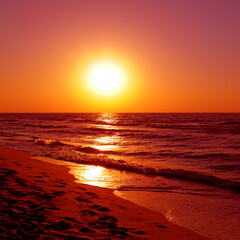 Bright red sunrise over the sea.