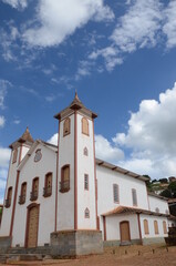 Fototapeta na wymiar Mother Church called Nossa Senhora da Imaculada Conceição at Serro/MG with blue sky in a sunny day