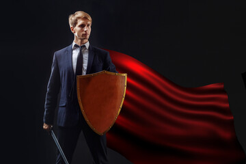 Super hero in a red cloak and with a shield and sword, the concept of an anti-crisis