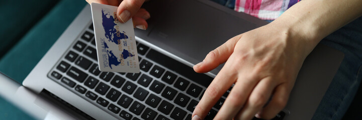 Woman holds laptop and credit card on her lap. Level financial literacy population. Mandatory forecast payments. Payment utility services. Calculate approximate amount purchases needed