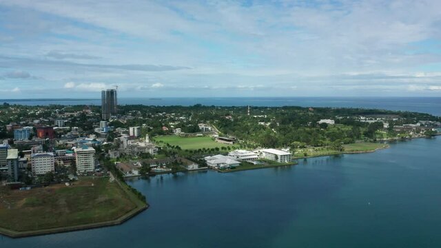 Aerial of peninsula city Suva on mainland of Fiji, view of Albert Park, urban