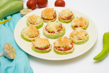 ingredients for cooking homemade zucchini mini portioned pizza with mozzarella and tomatoes, pepper and garlic. top view on a light background. organic light food for the body