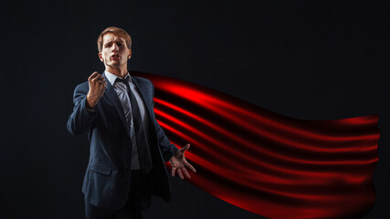 red-cloaked superhero gives a rousing speech, a young man in a suit and tie gives an inspirational...
