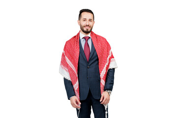 Handsome arabic businessman in suit and shemagh smiles on white blank background in studio. Business portrait of successful man