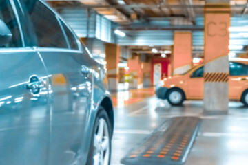 Parking lot blurred. Car lot parking space in underground city garage. Empty road asphalt background in soft focus. Ground floor for car parking.