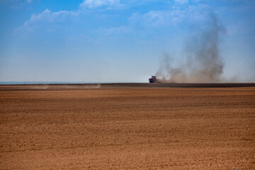 Fototapeta na wymiar Tractor plowing the fields in spring