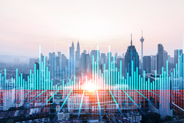 Fototapeta na wymiar Glowing FOREX graph hologram, aerial panoramic cityscape of Kuala Lumpur at sunset. Stock and bond trading in KL, Malaysia, Asia. The concept of fund management. Double exposure.