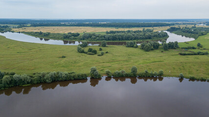 Aerial view of river Dnepr, Belarus. River and meadow from above. Landscape of fields and river. Space for text.