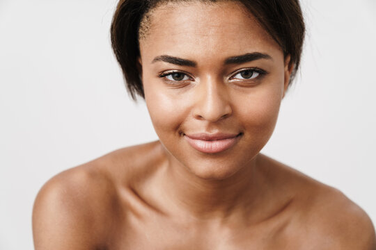 Image of half-naked african american woman smiling and looking at camera