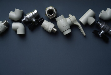 Plumbing background with fittings on a dark background