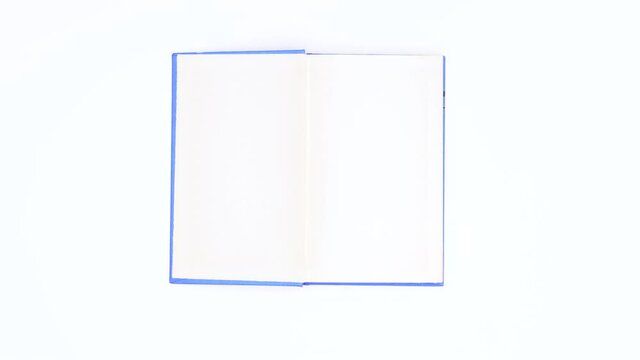 Light blue covered book appear and open. Stop motion 