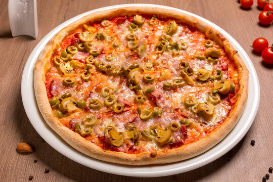 Capricciosa pizza thin cake, tomato sauce, ham, olives, mushrooms
